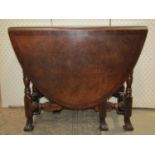 A good quality reproduction hardwood oval drop leaf gateleg dining table with two frieze drawers