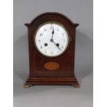 An inlaid Edwardian mahogany mantel clock with convex enamelled dial, French eight day striking