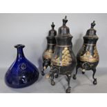 Three Dutch samovar with painted pastoral scenes and a blue glass decanter (4)