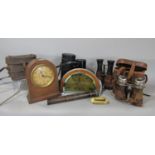 Two pairs of vintage binoculars and leather cases, a small brass telescope, a Prinzflex camera lens,