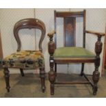 A 1920s oak carver chair with drop in upholstered seat raised on turned baluster supports united