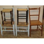 A pair of country made dining chairs with turned later painted frames and rush seats, together