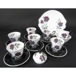A collection of Masquerade pattern coffee wares comprising serving plate, cream jug, sugar bowl, six