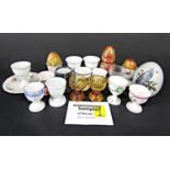 A collection of eggcups of varying design including continental examples, a pair of turned wooden