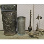 An embossed brass grape hod style demi-lune umbrella/stickstand, one other of cylindrical form,