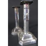 A pair of silver octagonal column candlesticks with stepped bases, 16.5 cm tall, Sheffield 1893,