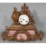 A Victorian gilt brass mantel clock enclosing French porcelain panels, probably by Sevres, with