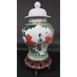 An oriental famille verte vase and cover, with painted decoration of figures in a landscape setting,