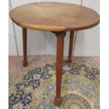 An oak cricket table, the circular top (mis-shaped) raised on three turned supports, 66cm diameter