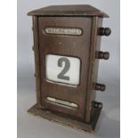 An early 20th century oak cased desk calendar, 19 cm high x 30 cm wide