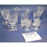 Five etched grape and vine glasses set on a square foot, fourteen matching wine and liquor glasses