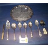 A collection of silver plated items to include scallop shaped tea tray, cutlery, toast rack, etc (