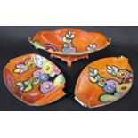 A collection of Carltonware art deco lustre wares in the Hollyhocks pattern on an orange ground