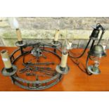 An antique style cast metal hanging ceiling light of circular open ring form supporting four