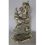 A Victorian brass Mrs Punch door stop with a miniature Mr Punch standing on her lap, 28 cm high x 21