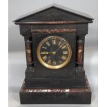 A mid-Victorian period black slate and polish marble mantel clock of architectural form, enclosing a