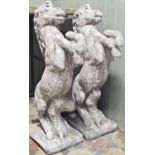A pair of cast composition stone pier/terrace caps in the form of rearing horses raised on square