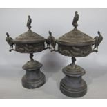 A pair of bronze 19th century tazzas with covers mounted on stands decorated with gun dogs and