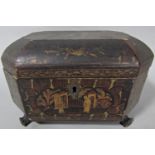 A Regency sarcophagus shaped lacquered tea caddy with chinoiserie decoration and hinged lid