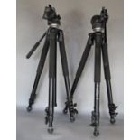 Two Manfrotto camera tripods with zip up carrying bags