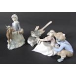 A Lladro figure group of a girl with a goat, further Lladro group of a pair of birds and a Lladro