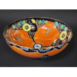 A Carltonware art deco lustre ware bowl in the Cubist Butterfly pattern on an orange ground, 25cm