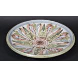 A Denby circular dish with painted decoration designed by Glyn Colledge with incised signature to