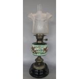 A Duplex oil lamp with brass stand, a floral font and a flared shade, 57 cm tall