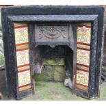 Three reclaimed cast iron fire inserts/grates, varying design, one enclosing floral printed