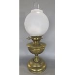 An Invicta oil lamp, brass stand and opaque spherical shade, 54 cm high