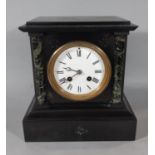 A Victorian black slate and polished marble mantel clock with enamelled dial and eight striking