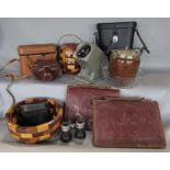 A miscellaneous collection of items, salad bowl, biscuit barrel, cameras, binoculars, leather