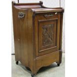 An Edwardian walnut coal box/perdonium with carved and panelled fall front with moulded outline