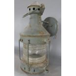 A wall mounted hurricane style lamp