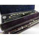 Two cased flutes, two tin whistles, together with various wind instrument component parts