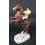 A Beswick model of a rearing horse with yellow jacketed huntsman for the Berkeley Hunt, impressed