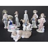 A collection of Lladro and Lladro Daisa figures comprising a boy carrying milk pails, two fisher