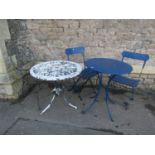 A cast aluminium garden terrace table with circular pierced top raised on swept supports, with