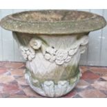 A good weathered composition stone garden urn, the circular tapered bowl with flared rim, lattice,