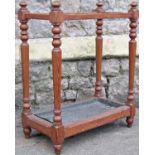 A Victorian pitched pine three divisional umbrella/stick stand of rectangular form raised on