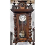 Late 19th century wall clock with eight day striking movement the walnut case with applied mouldings