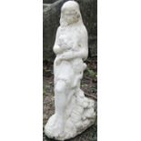 A cast composition stone garden ornament female figure resting beside a tree stump clutching a lamb,