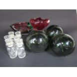 Two late 20th century heavy cut glass ashtrays, three green glass net floats and six spice bottles