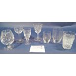 A collection of cut glass drinking glasses to include tumblers, stemmed wine glasses, brandy