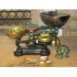 A vintage Libra cast iron kitchen scale with brass pans and weights, together with a further set