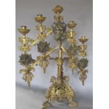 A 19th century portable brass altar candelabra with adjustable arms and height