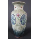 A large Royal Doulton vase with mottled green/grey glaze and moulded art nouveau style motifs,