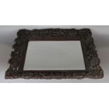 Chinese intricately carved hardwood framed bevelled mirror, 51 cm high x 43 cm wide
