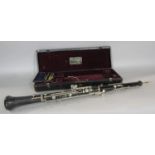 A cased oboe made by Rudall Carte & Co and a case of four reeds, 62.5 cm