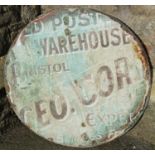 The remains of an old enamel sign mounted/applied to an iron tub lid, 80 cm in diameter